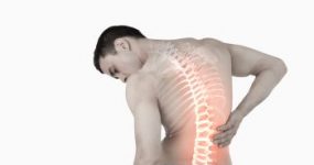 Man holding his lower back, his back is x-rayed
