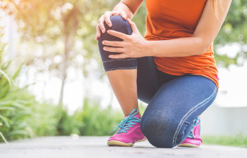 close up on a sore knee during training