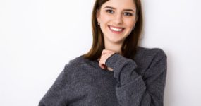 smiling brunette in a gray sweater