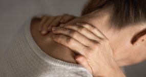 Woman having Shoulder and Neck pain at home. Muscle painful due to pain syndrome and Fibromyalgia, rheumatism, Cervical Spine